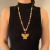 woman wearing a long atteza rose quartz necklace on black turtleneck