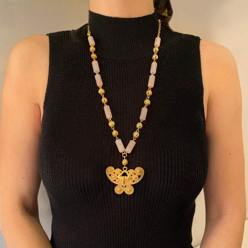 woman wearing a long atteza rose quartz necklace on black turtleneck